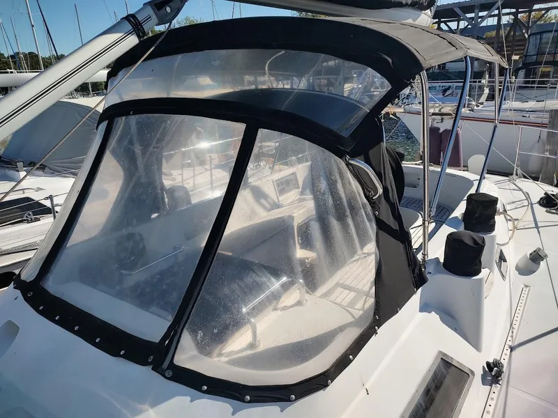 Slide: The Image of 1997 Hylas 46 sailboat cockpit with protective canopy in marina setting. - 16