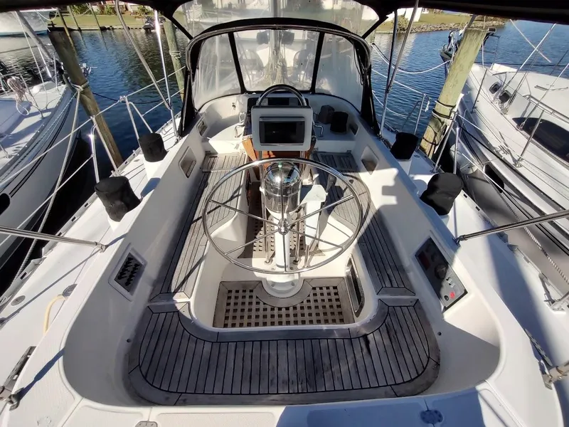 Slide: The Image of Cockpit of a 1997 Hylas 46 sailboat with steering wheel and navigation equipment. - 19