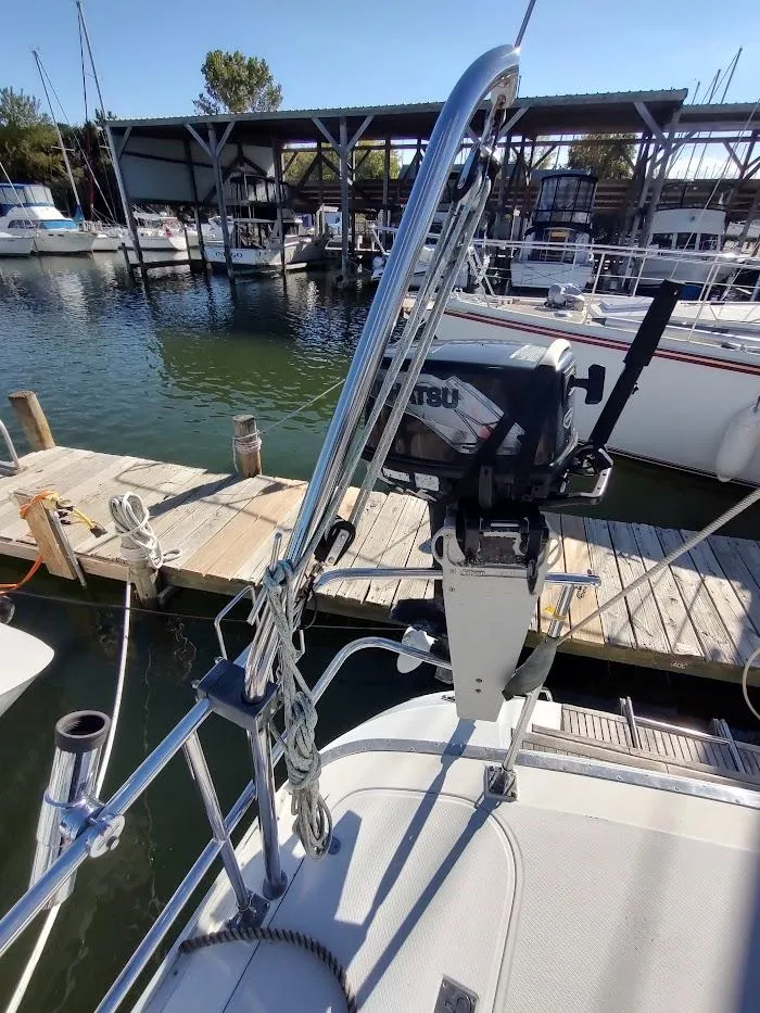 Slide: The Image of Sailboat Hylas 46, 1997 model, docked with visible outboard motor and marina background. - 25