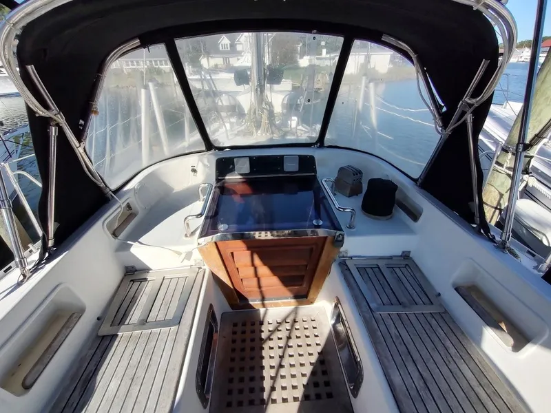 Slide: The Image of Cockpit of a 1997 Hylas 46 sailboat with wooden flooring and protective canopy. - 26