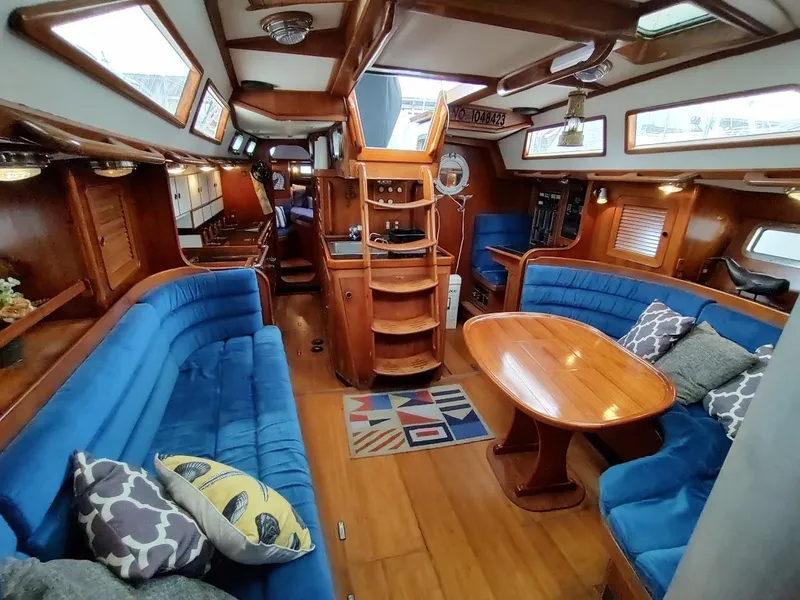 Slide: The Image of Luxurious interior of a 1997 Hylas 46 yacht with blue seating and wooden finishes. - 28