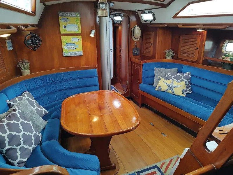 Slide: The Image of Cozy interior of 1997 Hylas 46 yacht with blue seating and wooden table. - 30