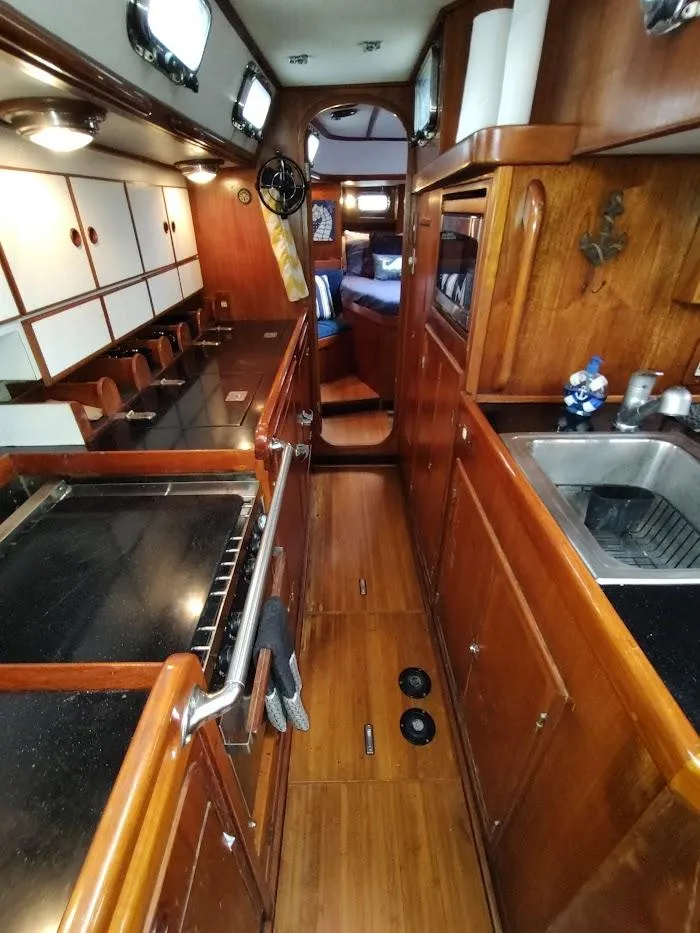 Slide: The Image of 1997 Hylas 46 yacht interior with wooden cabinetry and modern kitchen amenities. - 41