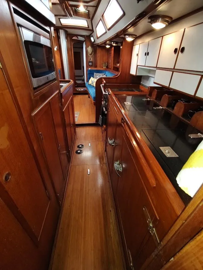 Slide: The Image of Interior of a 1997 Hylas 46 yacht with wooden cabinetry and modern amenities. - 42