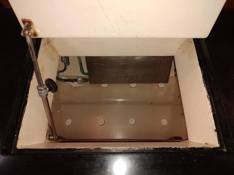 Slide: The Image of Open compartment in a 1997 Hylas 46 yacht, showing internal components and wiring. - 47