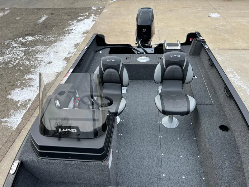 Slide: The Image of 2025 Lund 1650 Rebel XL SS Blackout boat interior with seating and steering console. - 10
