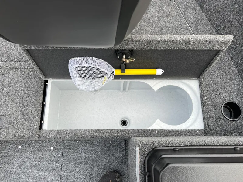Slide: The Image of 2025 Lund 1650 Rebel XL SS Blackout boat storage compartment with net and yellow handle. - 13