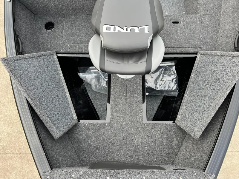 Slide: The Image of 2025 Lund 1650 Rebel XL SS Blackout boat interior with storage compartments and seat. - 15