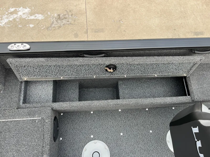 Slide: The Image of 2025 Lund 1650 Rebel XL SS Blackout boat interior storage compartments. - 17