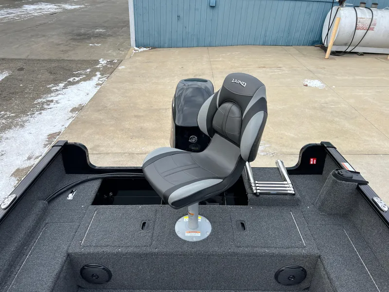 Slide: The Image of 2025 Lund 1650 Rebel XL SS Blackout boat interior with swivel seat and storage compartments. - 19