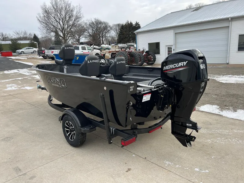 Slide: The Image of 2025 Lund 1650 Rebel XL SS Blackout boat with Mercury engine on a trailer. - 4