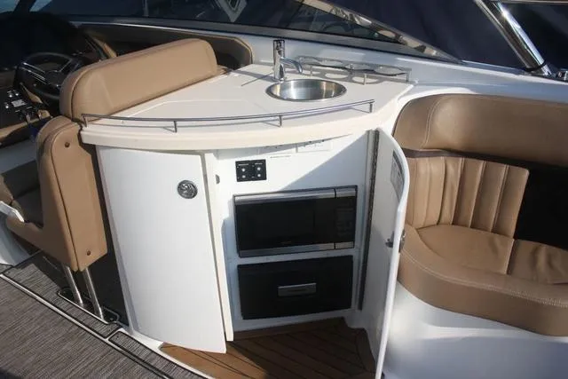 Slide: The Image of 2022 Cobalt R35 boat interior with kitchenette and seating area. - 10