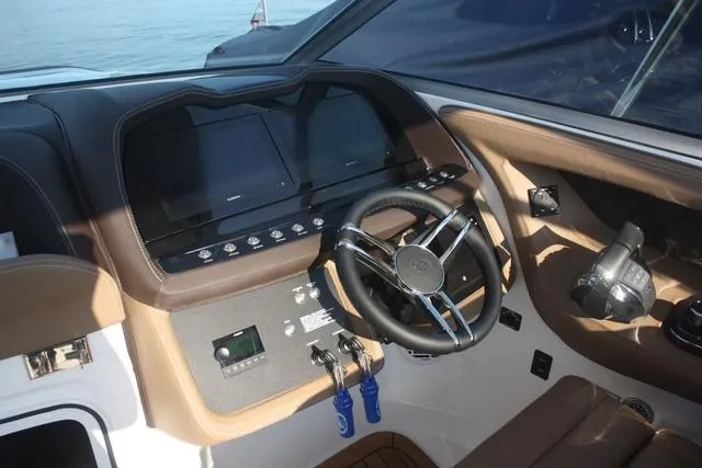 Slide: The Image of 2022 Cobalt R35 boat dashboard with steering wheel and control panel. - 9