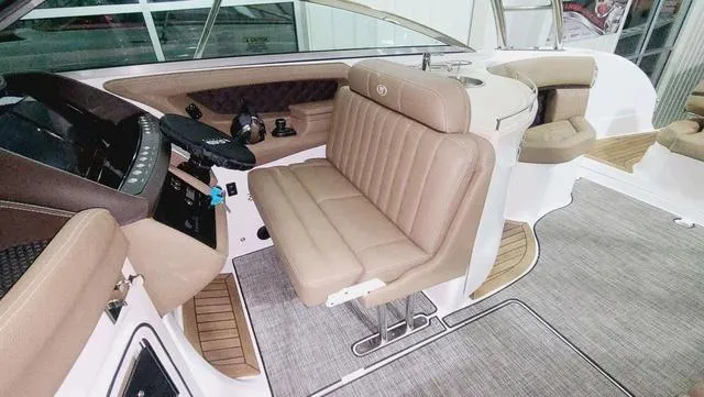 Slide: The Image of Interior of 2022 Cobalt R35 boat with beige seating and modern dashboard. - 8