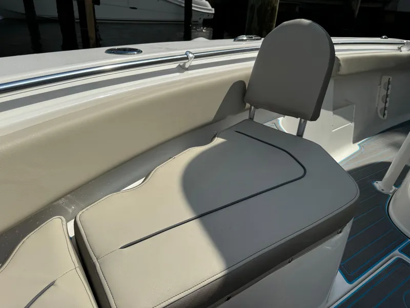 Slide: The Image of 2024 Key West 239 FS boat seat with beige upholstery and sleek design. - 11