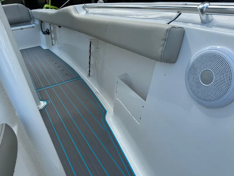 Slide: The Image of 2024 Key West 239 FS boat interior with cushioned seating and speaker. - 15