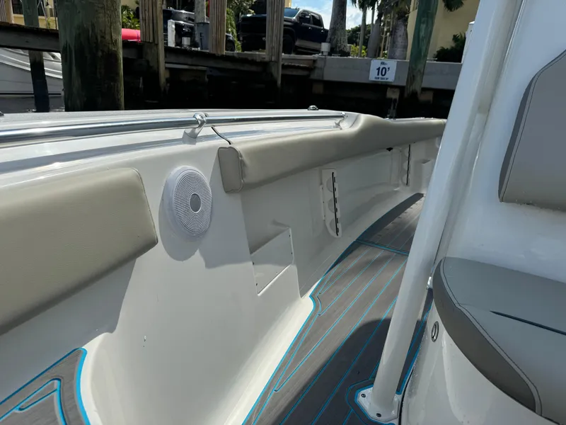 Slide: The Image of 2024 Key West 239 FS boat interior with cushioned seating and speaker. - 16