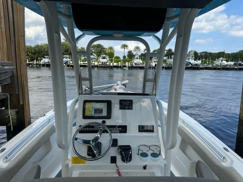 Slide: The Image of 2024 Key West 239 FS boat dashboard with steering wheel and navigation system. - 17