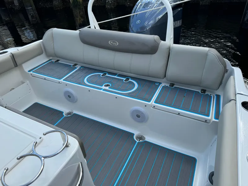 Slide: The Image of 2024 Key West 239 FS boat interior with cushioned seating and LED floor lighting. - 25