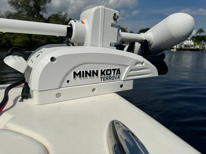 Slide: The Image of Minn Kota Terrova motor on 2024 Key West 239 FS boat, docked on a sunny day. - 27