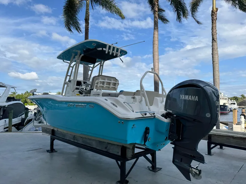 Slide: The Image of 2024 Key West 239 FS boat with Yamaha engine, docked under palm trees. - 3