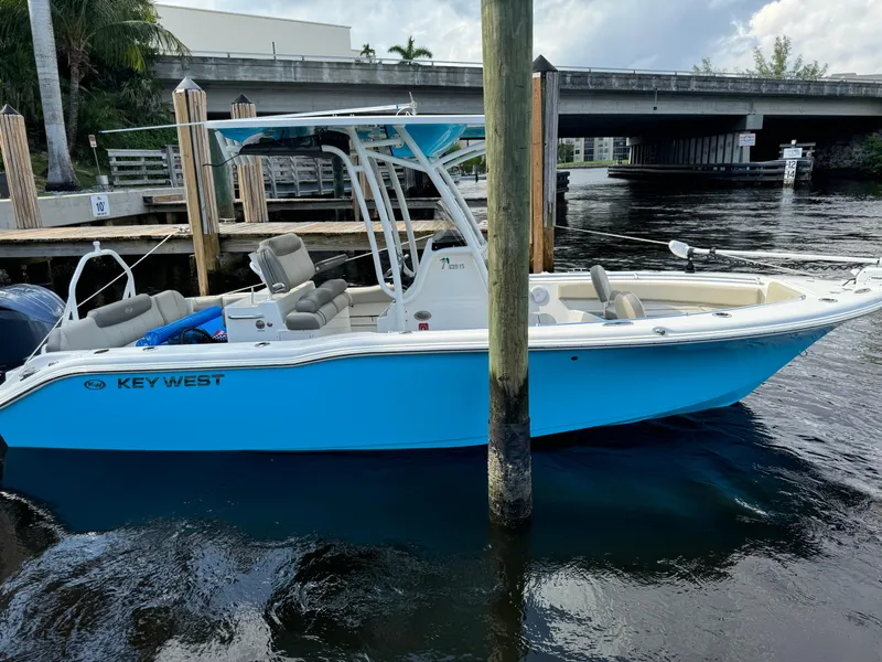 Slide: The Image of 2024 Key West 239 FS boat docked on calm water near a bridge. - 5