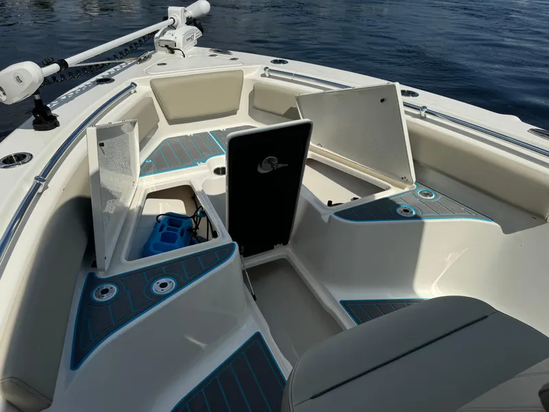 Slide: The Image of 2024 Key West 239 FS boat interior with open storage compartments on calm water. - 8
