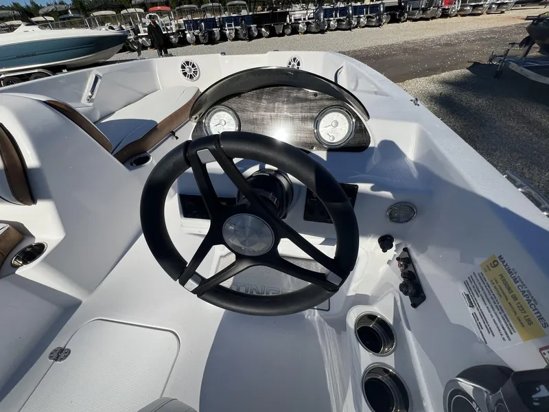 Slide: The Image of 2025 Stingray SC 182SC boat dashboard with steering wheel and gauges. - 10