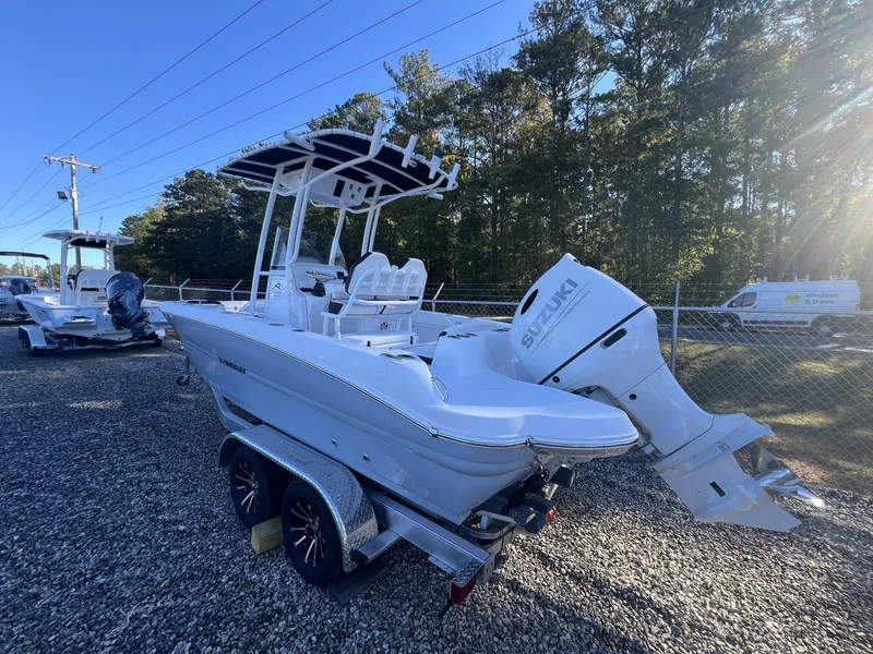 Slide: The Image of 2025 Stingray CC 216 CC boat with Suzuki outboard motor on a trailer. - 12
