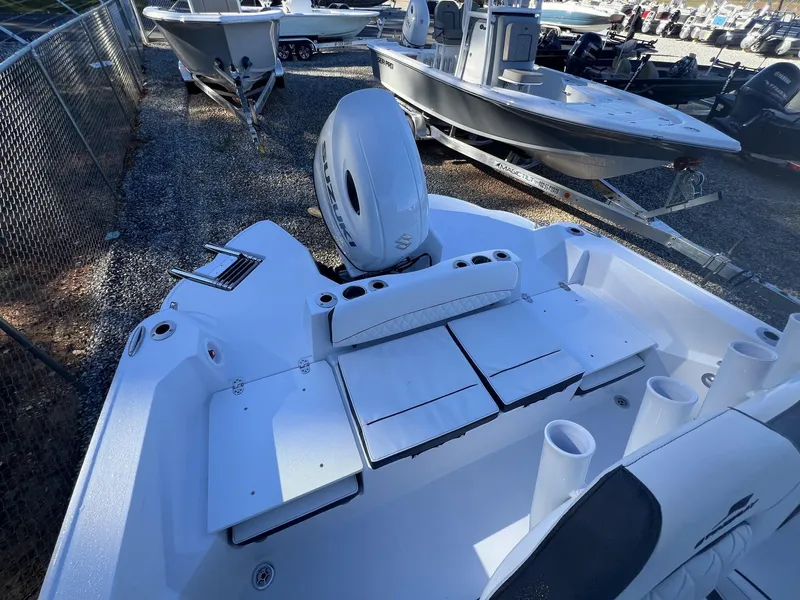 Slide: The Image of 2025 Stingray CC 216 CC boat with Suzuki outboard motor in a marina setting. - 7