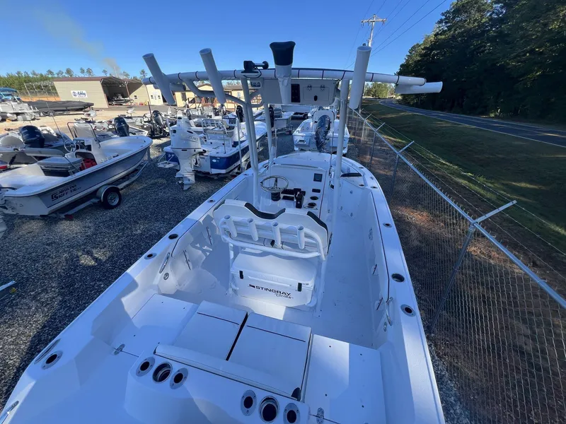 Slide: The Image of 2025 Stingray CC 216 CC boat in a marina, surrounded by other vessels. - 9