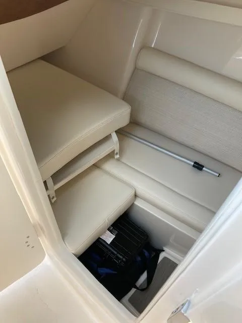 Slide: The Image of 2018 Grady-White Freedom 325 cabin interior with seating and storage. - 14