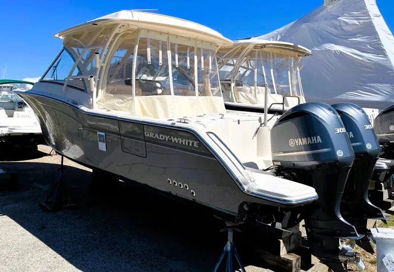 Slide: The Image of 2018 Grady-White Freedom 325 boat with twin Yamaha engines, docked outdoors. - 3