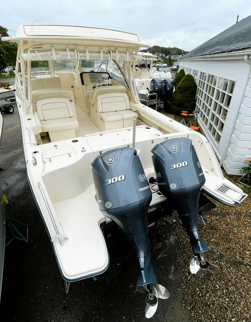Slide: The Image of 2018 Grady-White Freedom 325 boat with dual 300 HP engines, docked outdoors. - 7