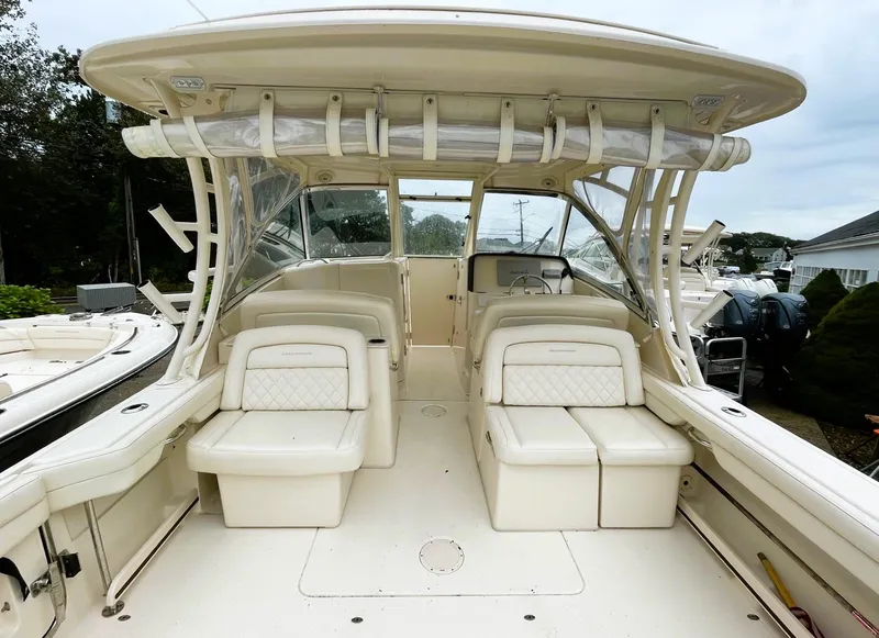 Slide: The Image of 2018 Grady-White Freedom 325 boat interior with seating and helm. - 8