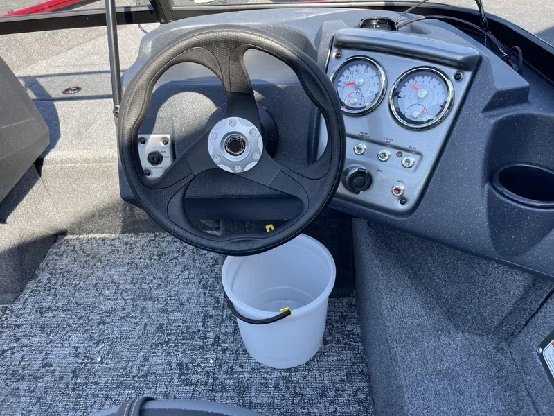 Slide: The Image of 2025 Tracker Pro Guide V-16 WT boat dashboard with steering wheel and gauges. - 11