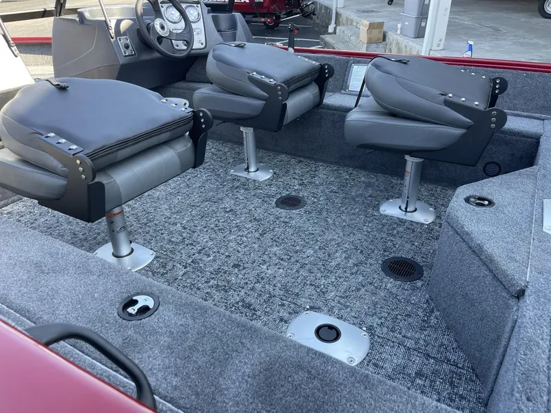 Slide: The Image of 2025 Tracker Pro Guide V-16 WT boat interior with swivel seats and carpeted flooring. - 5