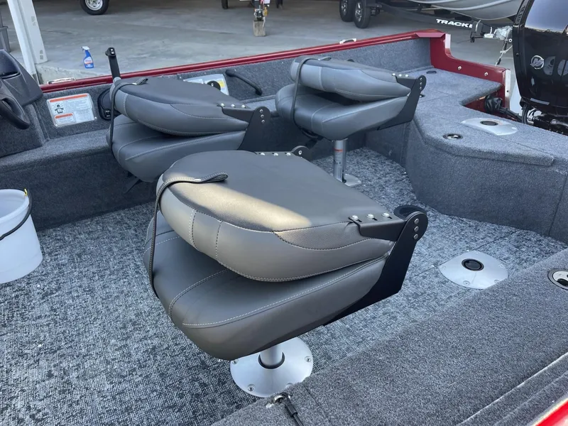 Slide: The Image of 2025 Tracker Pro Guide V-16 WT boat interior with gray seating and carpeted flooring. - 6