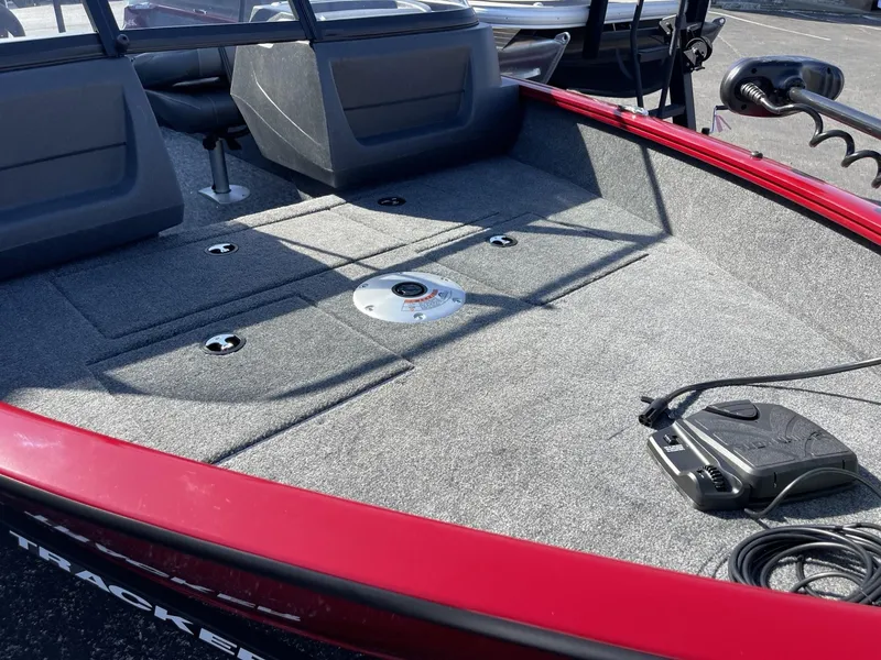 Slide: The Image of 2025 Tracker Pro Guide V-16 WT boat interior with carpeted deck and seating. - 9