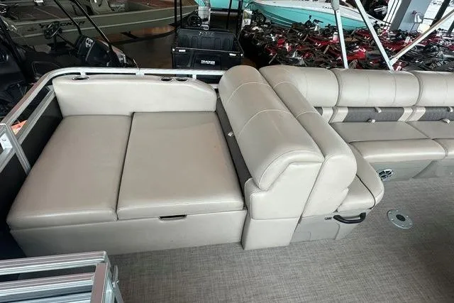 Slide: The Image of 2025 Sun Tracker Sportfish 24 XP3 boat interior with beige seating and spacious layout. - 6