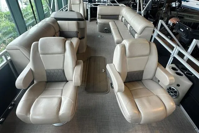 Slide: The Image of 2025 Sun Tracker Sportfish 24 XP3 interior with luxurious beige seating and spacious layout. - 2