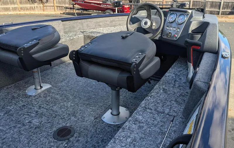 Slide: The Image of 2025 Tracker Pro Guide V-16 SC boat interior with seating and dashboard. - 3