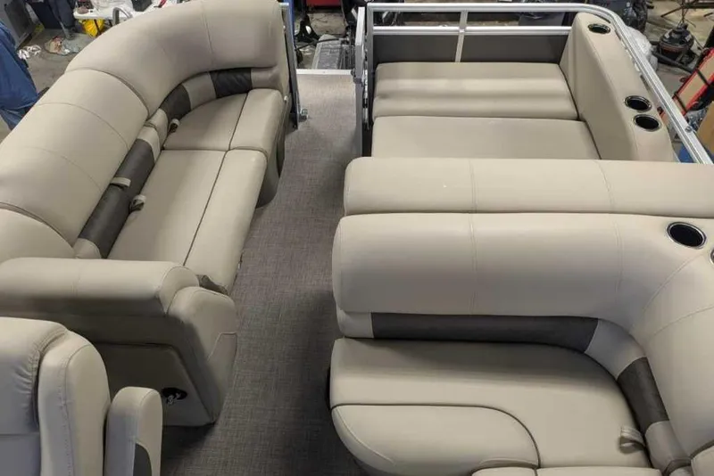 Slide: The Image of 2025 Sun Tracker Party Barge 22 RF DLX interior with plush seating and cup holders. - 2
