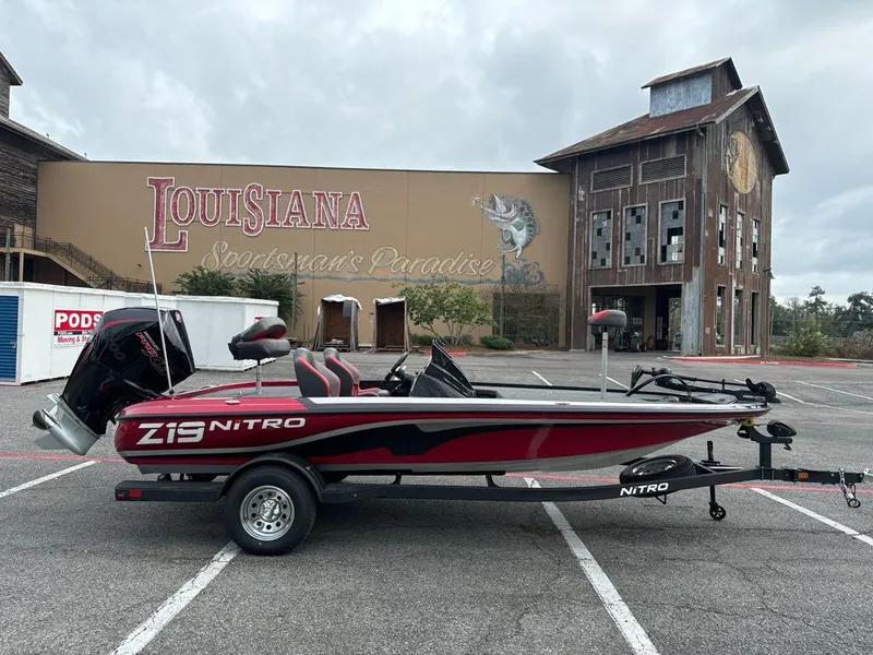 Slide: The Image of 2025 Nitro Z19 boat parked in front of Louisiana-themed building. - 2