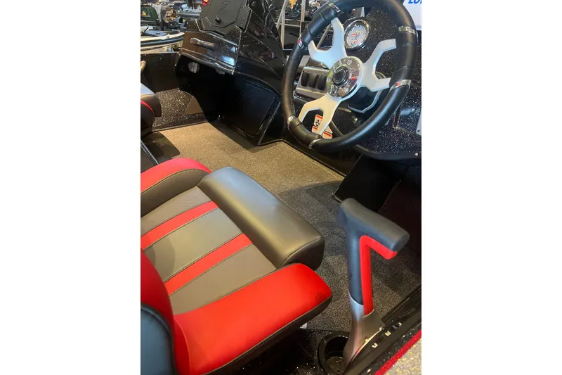 Slide: The Image of 2025 Nitro Z19 boat interior with red and gray seating, steering wheel, and controls. - 9