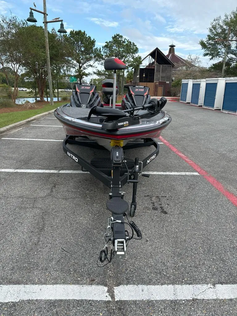 Slide: The Image of 2025 Nitro Z19 boat parked in a lot, surrounded by trees and buildings. - 3