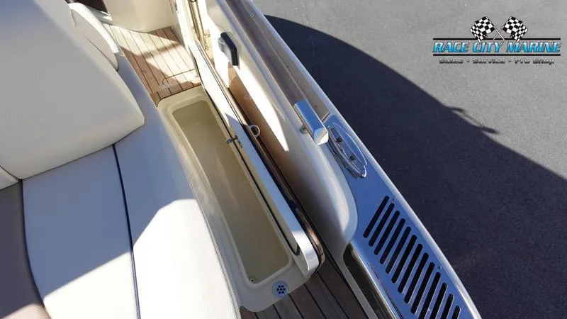 Slide: The Image of 2025 Chris-Craft 28GT boat interior with open storage compartment and sleek design. - 13