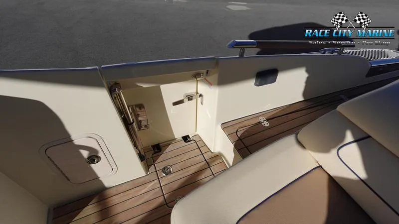 Slide: The Image of Interior view of 2025 Chris-Craft 28GT boat with teak flooring and seating. - 14
