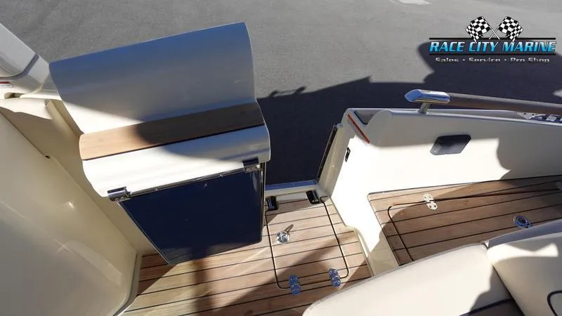 Slide: The Image of 2025 Chris-Craft 28GT boat interior with teak flooring and seating. - 15
