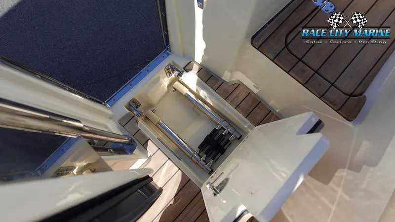 Slide: The Image of 2025 Chris-Craft 28GT boat interior with wooden flooring and storage compartment. - 16